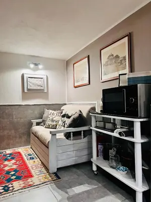 a living room with a couch and a tv at La Casetta Paternò “Nel Cuore Pulsante di Palermo” in Palermo