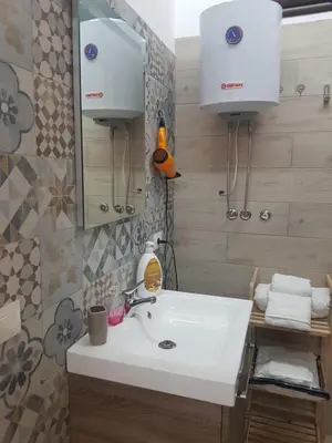 a bathroom with a white sink and a mirror at Casa dolce casa in Partinico
