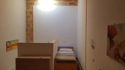 a small room with a bed and a cabinet at Casa dolce casa in Partinico