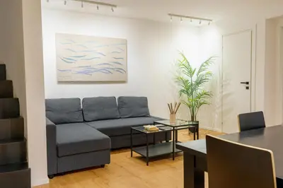 a living room with a couch and a table at Parlamento Apartment - Esclusivo 120mq centro storico Palermo in Palermo