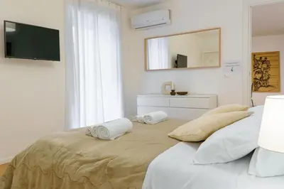 a bedroom with a bed with two towels on it at Parlamento Apartment - Esclusivo 120mq centro storico Palermo in Palermo