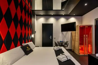 a bedroom with a white bed and a red wall at Maximum hub suite&spa in Palermo