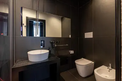 a bathroom with a sink and a toilet and a mirror at Maximum hub suite&spa in Palermo