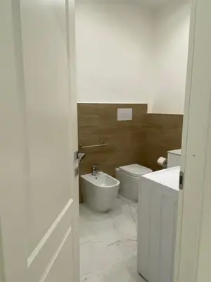a bathroom with a white toilet and a sink at Vittorio Emanuele & Quattro Canti Suite Palermo in Palermo