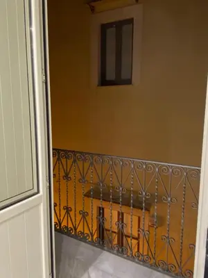 a balcony with a table and a railing at Vittorio Emanuele & Quattro Canti Suite Palermo in Palermo