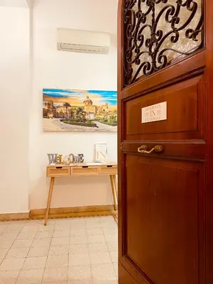 a desk in a room with a wooden door at Palermo Center Residenza IN Cattedrale Superior Apartment in Palermo
