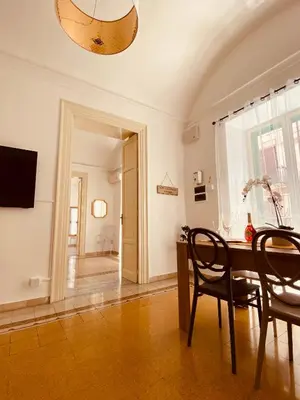 a dining room with a table and chairs and a television at Palermo Center Residenza IN Cattedrale Superior Apartment in Palermo