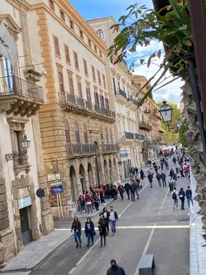 a group of people walking down a city street at Palermo Center Residenza IN Cattedrale Superior Apartment in Palermo