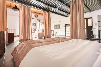a bedroom with a large bed in a room at Tavola tonda apartament in Palermo