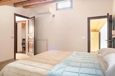 a bedroom with a large bed in a room at Tavola tonda apartament in Palermo