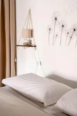 a bedroom with a bed with a dandelion sign on the window at Tavola tonda apartament in Palermo
