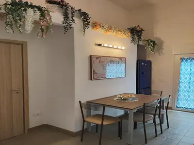 a dining room with a table and chairs at Seafront Apartment in Villa with Swimming Pool and Parking in Alcamo Marina