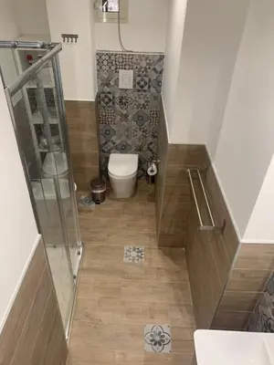 a small bathroom with a toilet and a shower at San Saverio Home in Palermo