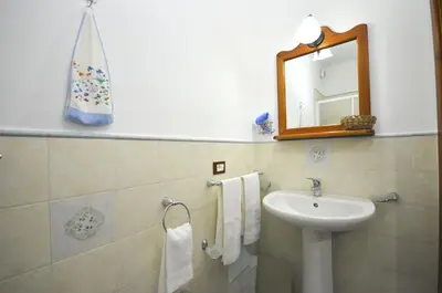 a bathroom with a sink and a mirror at Cascina degli Ulivi in Castelluzzo