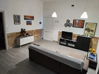 a living room with a couch and a tv at Alcamo Marina Villa Pool in Alcamo Marina