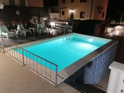 a large swimming pool with blue water in a building at Alcamo Marina Villa Pool in Alcamo Marina