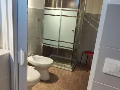 a bathroom with a toilet and a glass shower at Alcamo Marina Villa Pool in Alcamo Marina