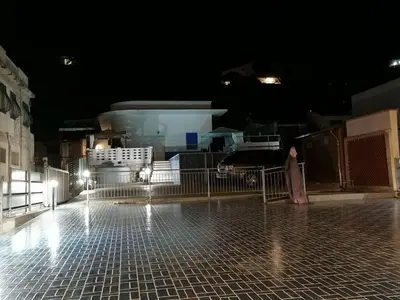 a person standing on a tiled floor at night at Alcamo Marina Villa Pool in Alcamo Marina