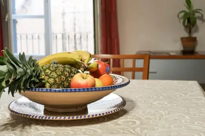 a bowl of fruit sitting on top of a table at N'Amuri di Casa in Palermo