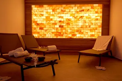 a room with two chairs and a large window at Resort La Battigia Beach & Spa in Alcamo Marina