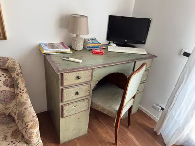 a desk with a computer on top of it at Meetup on The Terrace View With private parking in Palermo