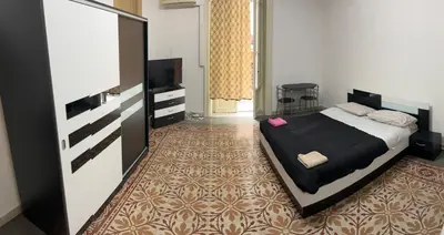 a bedroom with a bed and a television in it at Manzoni rooms in Palermo