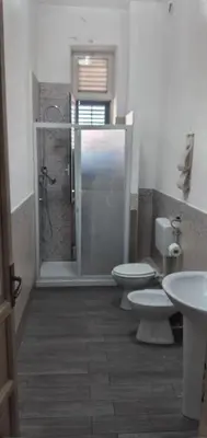 a bathroom with two toilets and a shower at Manzoni rooms in Palermo