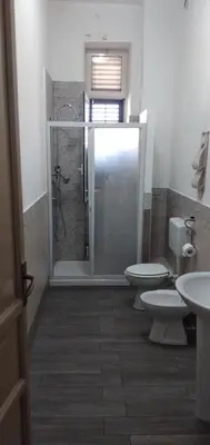 a bathroom with two toilets and a shower at Manzoni rooms in Palermo