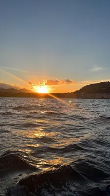 a sunset over a body of water with waves at Villa GLORIA intero alloggio sulla spiaggia 8 posti letto 15 minuti da Palermo e 35 da Cefalu in Casteldaccia