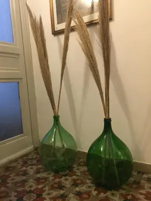 two green vases sitting on a floor next to a door at Verdi Apartment in Castellammare del Golfo
