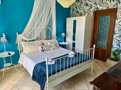 a bedroom with a bed with a white canopy at Case Vanella Grande aspra bagheria in Bagheria