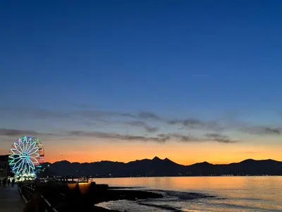 a ferris wheel in the water at sunset at CASE VANELLA GRANDE aspra Bagheria in Bagheria