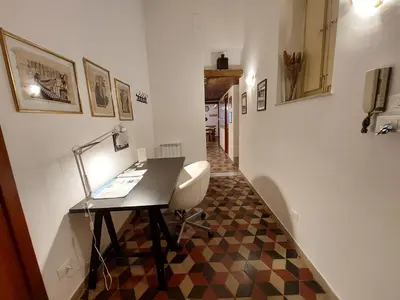 a office with a desk and a chair in a hallway at Olivuzza Apartment in Palermo