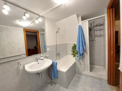 a bathroom with a sink and a tub and a shower at Olivuzza Apartment in Palermo
