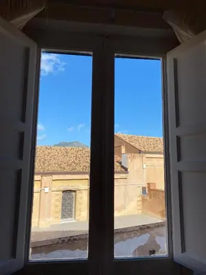 an open window with a view of a building at Dimora Sinibaldi in Palermo