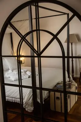 a bedroom with a bed in a room with an iron cage at Dimora Sinibaldi in Palermo