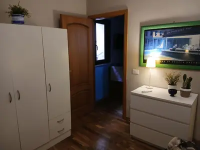 a room with a white cabinet and a dresser with a lamp at Casa da Michelino in Palermo