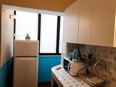 a kitchen with a refrigerator and a counter top at Casa da Michelino in Palermo
