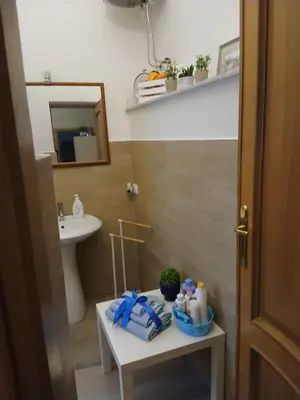 a bathroom with a sink and a table with towels at Casa da Michelino in Palermo