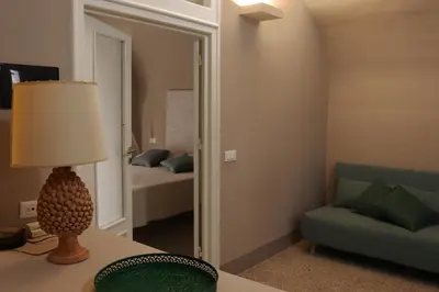 a living room with a couch and a mirror at Palazzo Cutò suite & charme in Palermo