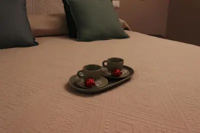 two cups on a tray on a bed at Palazzo Cutò suite & charme in Palermo