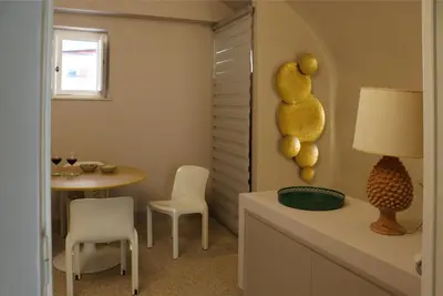 a kitchen with a table and chairs and a table and a dining room at Palazzo Cutò suite & charme in Palermo