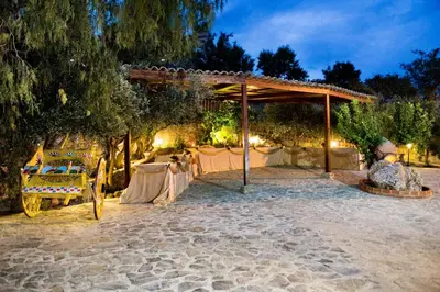 a table set up for a wedding at night at Hotel La Rocca in Roccapalumba
