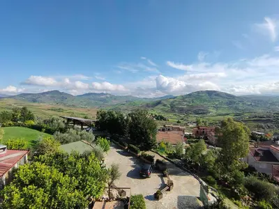 a view of a town with mountains in the background at Hotel La Rocca in Roccapalumba