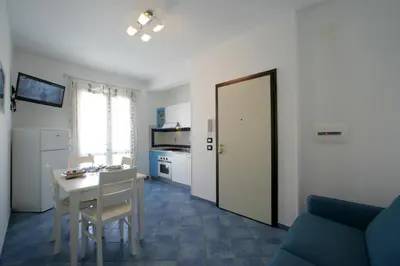 a living room with a table and a kitchen at Venere ed Enea - Appartamenti Vista Mare in San Vito lo Capo