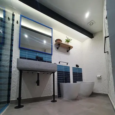 a bathroom with two toilets and a sink and a mirror at Casa Zagato Le Fuoriserie in Palermo