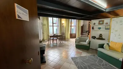 a living room with a couch and a table at Casa Monviso Le fuoriserie in Palermo