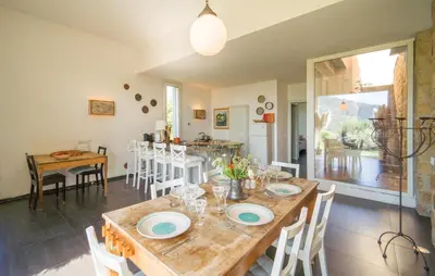 a dining room with a wooden table and chairs at Cerasuola in Alia