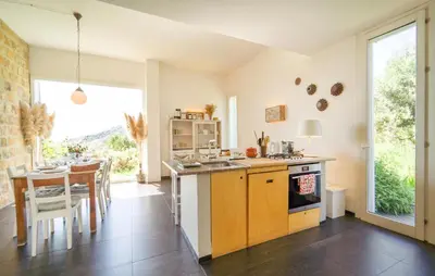 a kitchen with a table and a stove top oven at Cerasuola in Alia