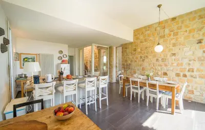 a kitchen and dining room with a table and chairs at Cerasuola in Alia